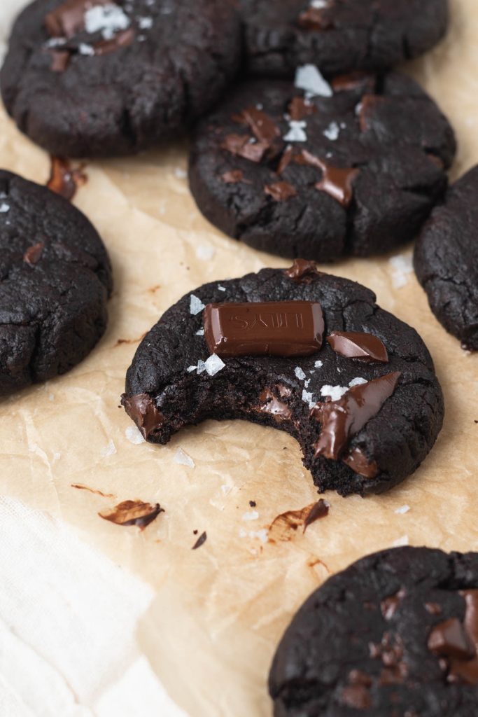 a bite out of a chocolate chunk cookie with sea salt